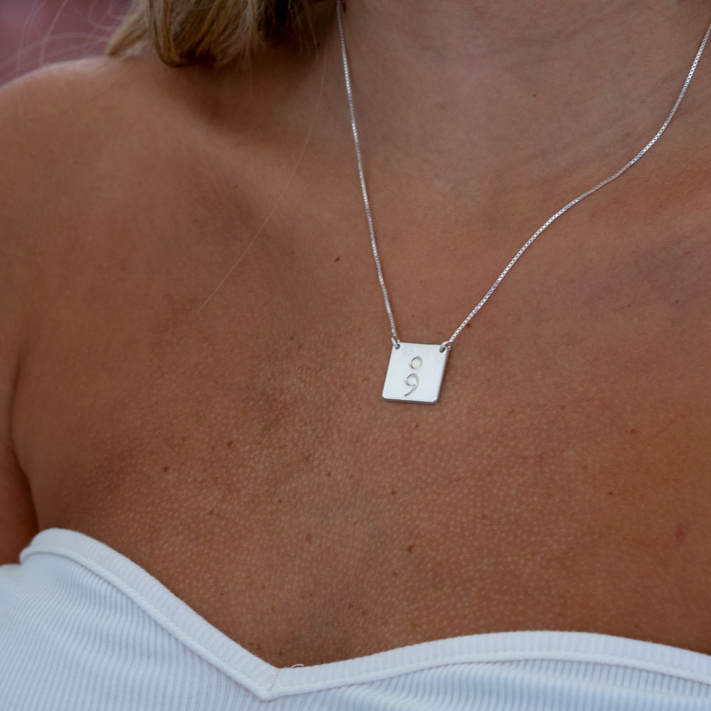 Square Semicolon Necklace on a model