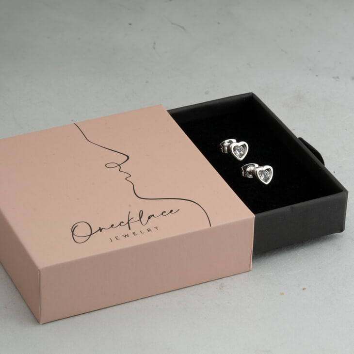 Heart diamond earrings showcased in a modern jewelry gift box.