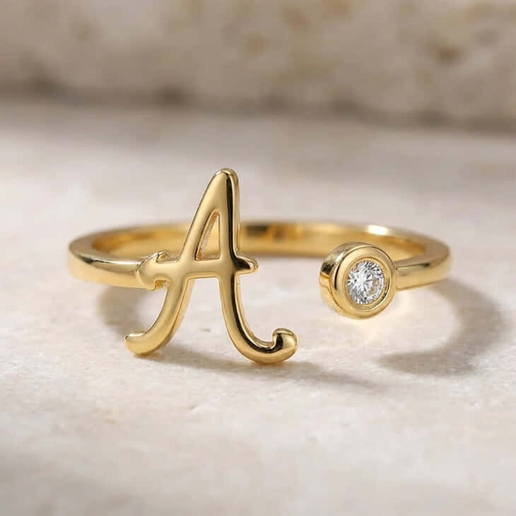 Cursive initial ring in gold showcasing a beautiful gemstone