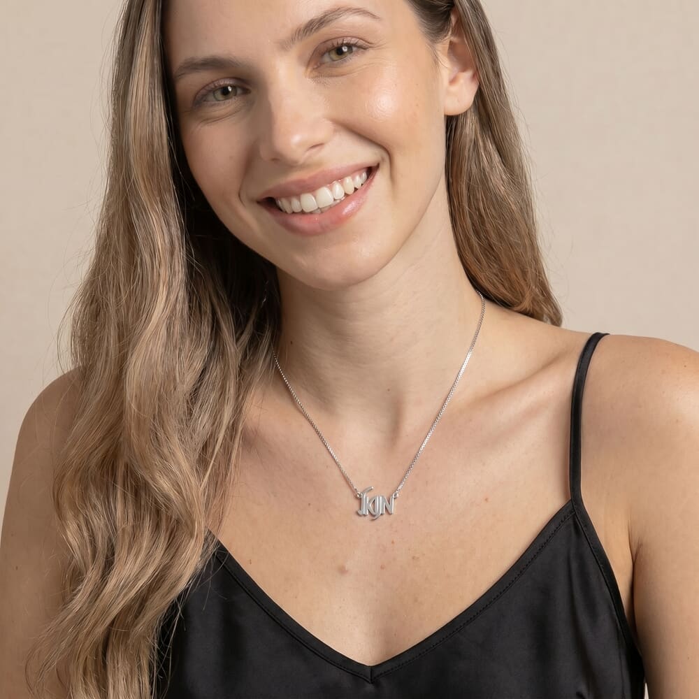 Model highlighting HB28369 necklace featuring a contemporary letter design in a simple backdrop