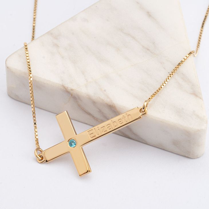 cross with birthstone and name information