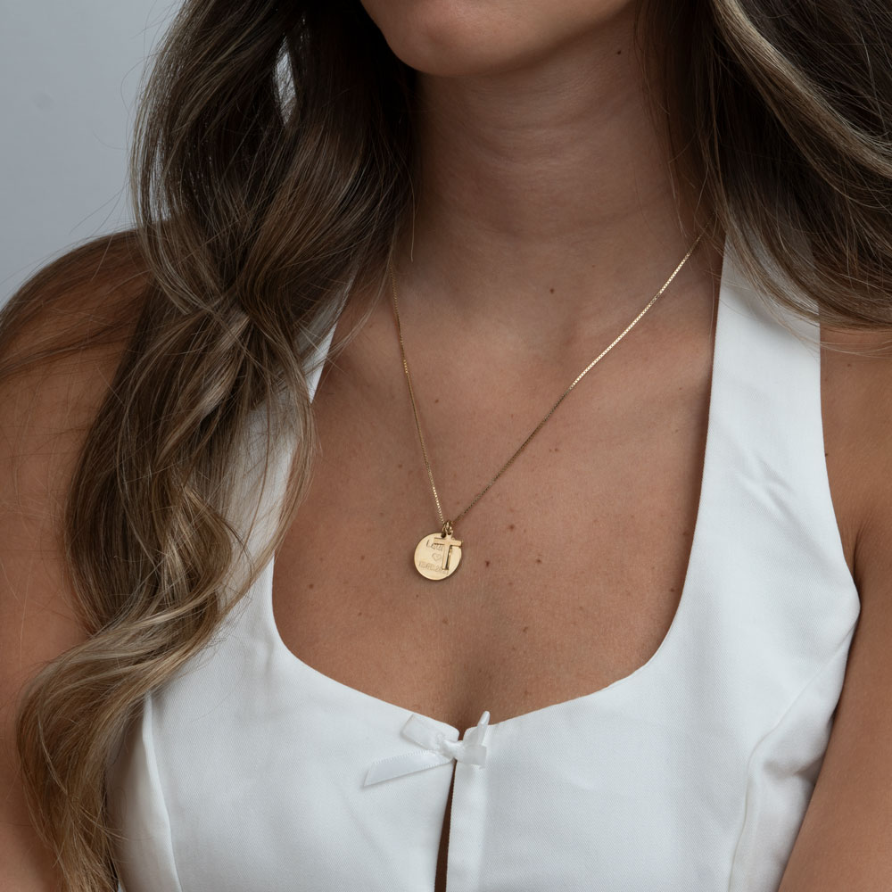 Engraved round pendant and cross on a model - 2