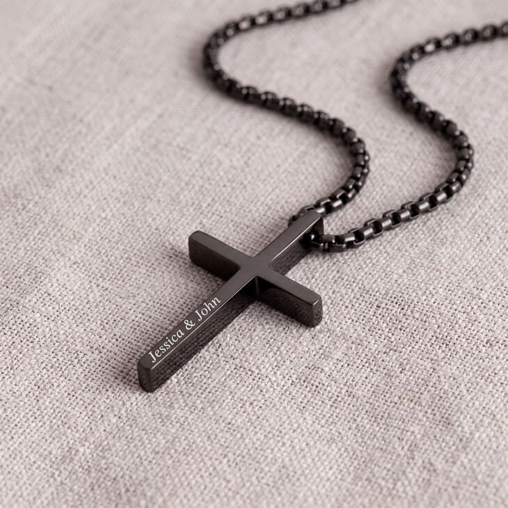 Detailed shot of Engraved Black Cross Necklace with focus on engraved names