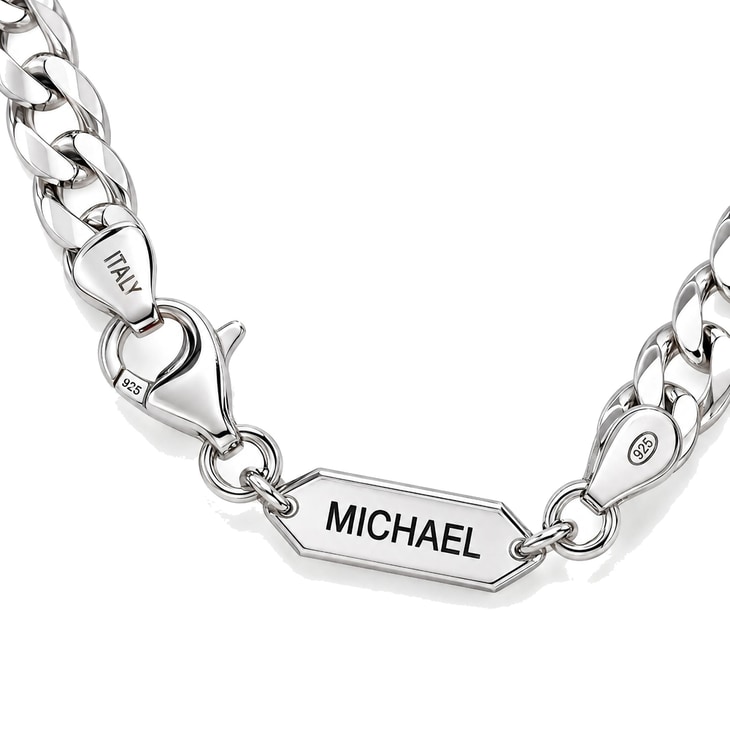 Close-up view of personalized Cuban necklace with engraved bar reading MICHAEL