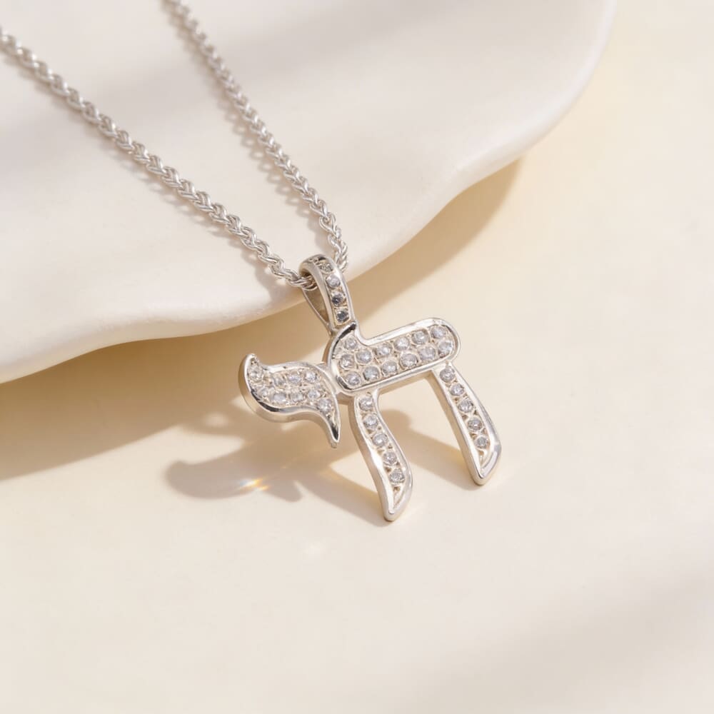Model displays the Handmade Hebrew Chai Necklace with Zircons, enhancing her chic outfit effortlessly.