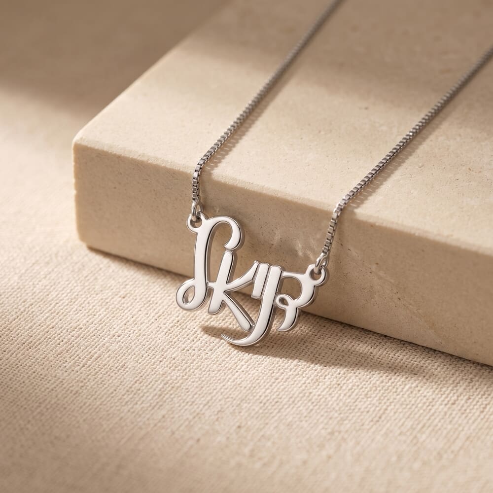 Model features Hebrew name necklace in stylish Ahava script, resting on a warm-toned surface.