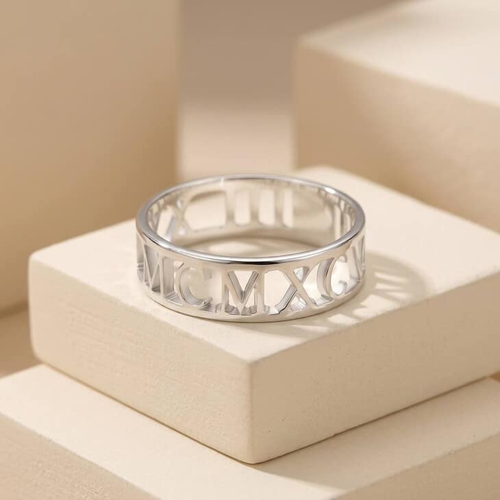 Model displaying a Mens Roman Numeral Ring with a relaxed pose against a neutral backdrop