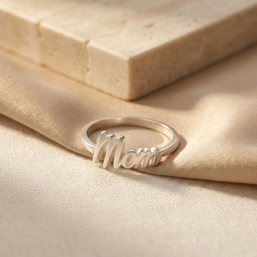 Dainty Mom Ring beautifully displayed on a light fabric surface, capturing its unique look