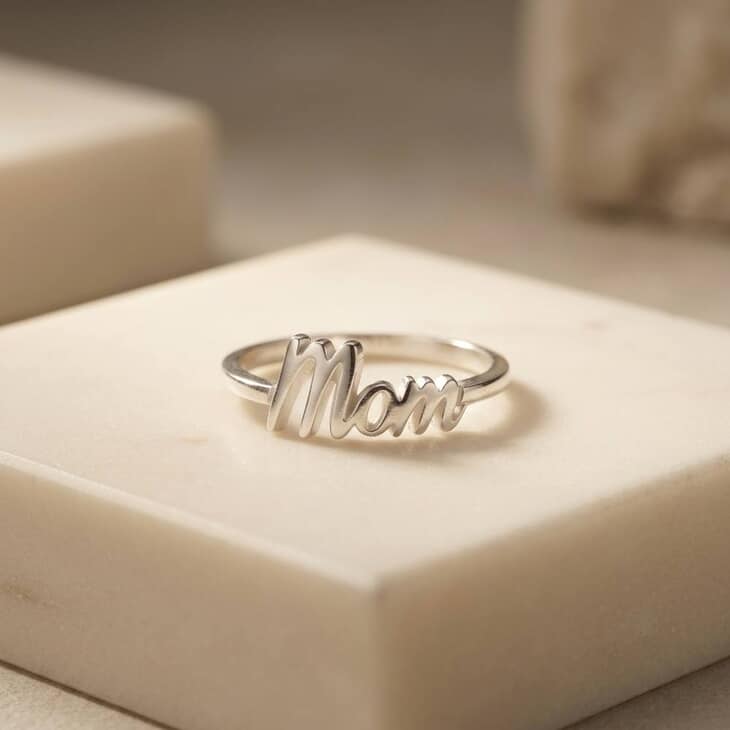 Dainty Mom Ring elegantly worn by a model, complemented by a neutral environment