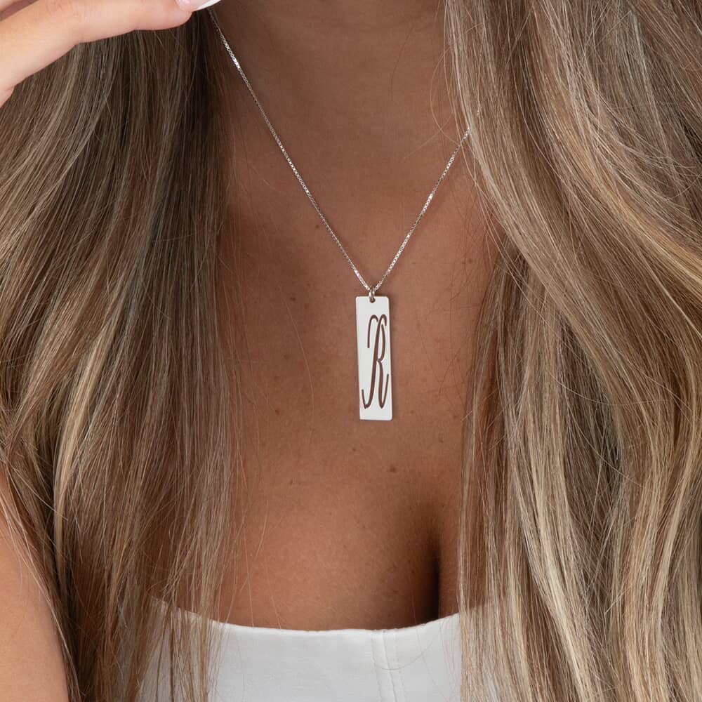 Cutout Initial Bar Necklace on a model