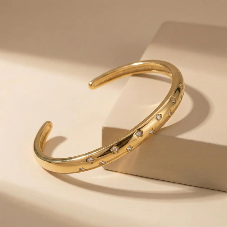 Celestial Star cuff bracelet positioned on a soft surface, highlighting its cubic zirconia star accents