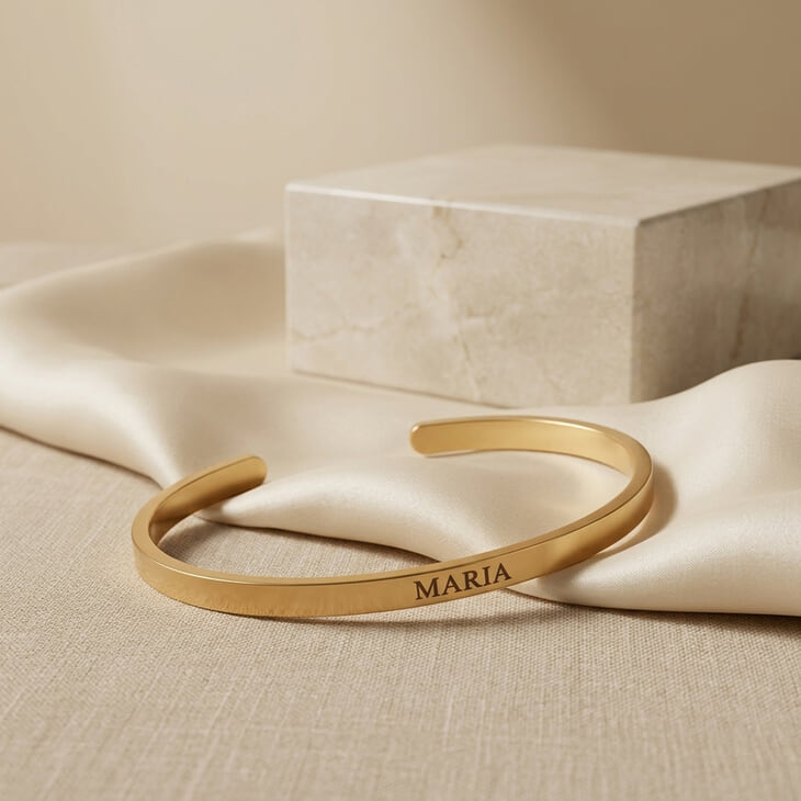 Personalized Thin Open Bangle Bracelet showcasing 'MARIA' engraving on smooth draped fabric