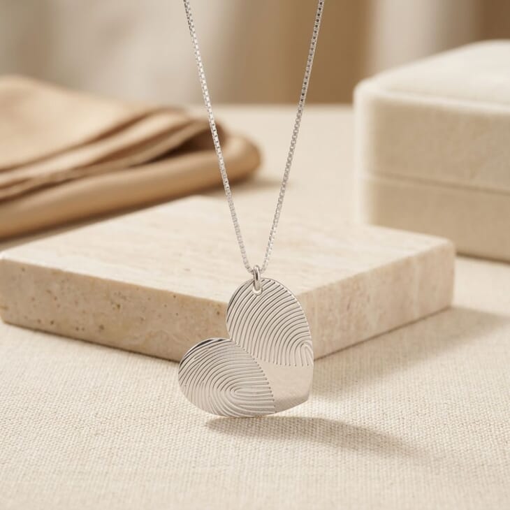Close-up shot of the Personalized Double Fingerprint Heart Necklace, focusing on the engraved heart pendant.