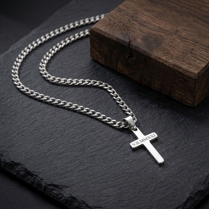 Silver Custom Cross Necklace featuring a curb chain on a black stone base