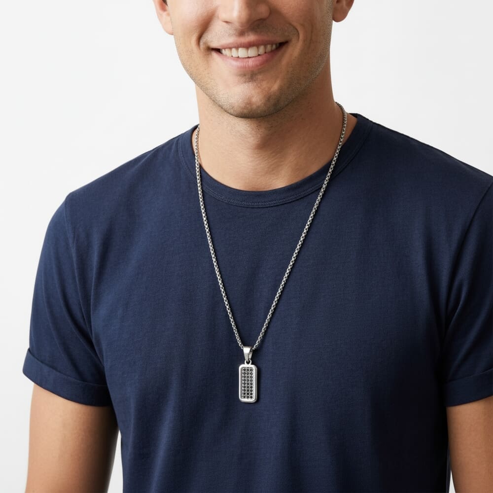 Man sporting Men's Black Zircon Tag Necklace, accentuating the sleek rectangular pendant with a relaxed look