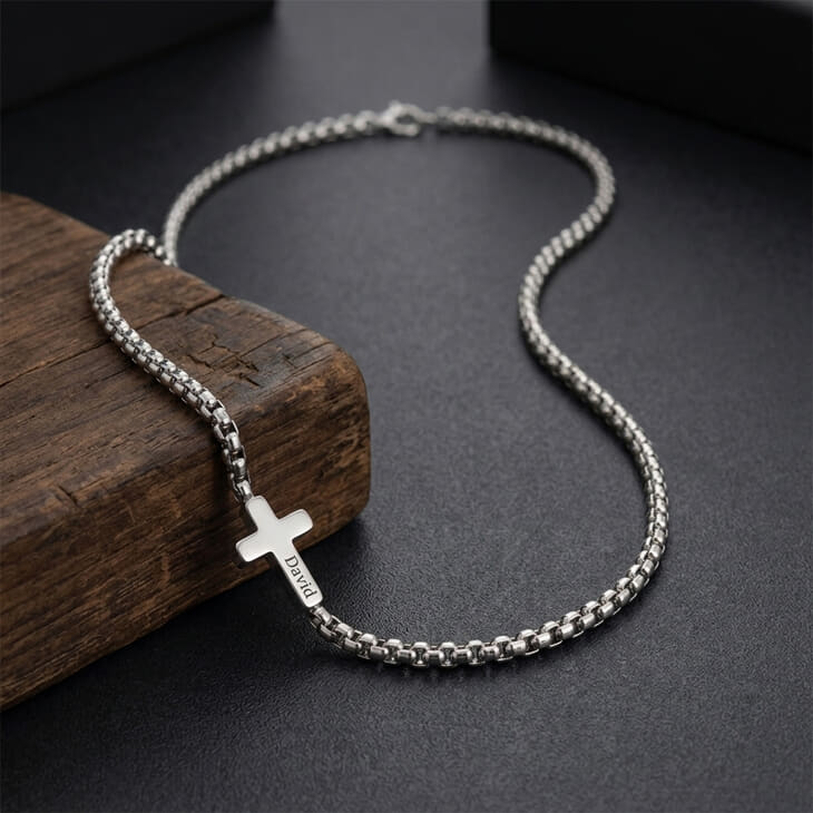 Stylish silver Men's Sideways Cross Necklace on a wooden table