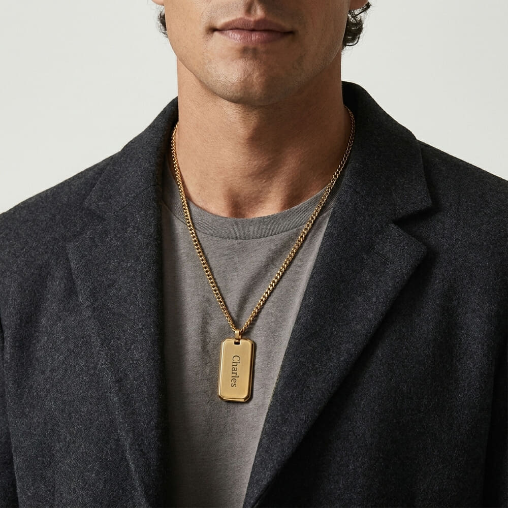 Man presenting custom engraved dog tag necklace for men with relaxed look