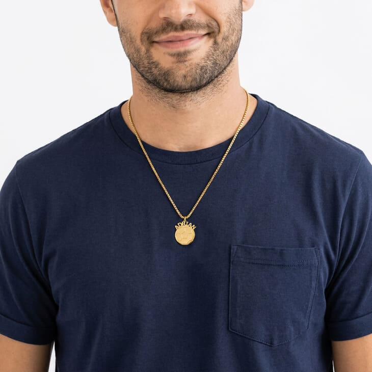 Model highlighting a Personalized Soccer Ball Name Necklace paired with a navy T-shirt