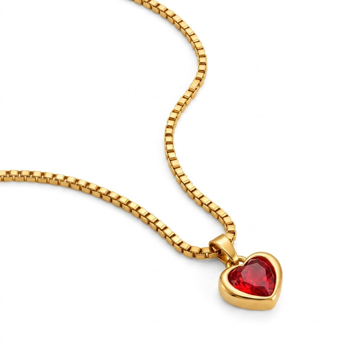 Gold heart necklace accented by a striking ruby heart stone