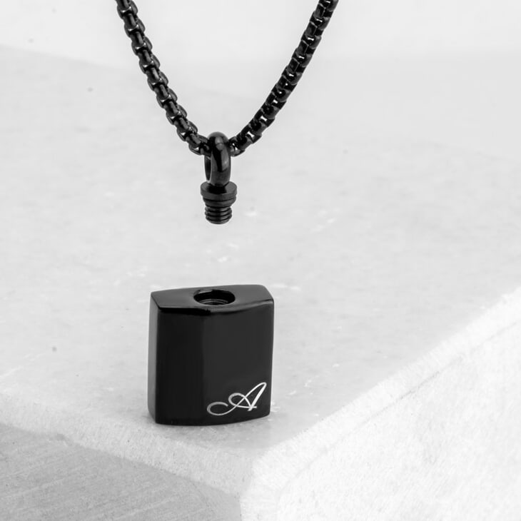 Chic personalized black urn necklace, featuring a silver finish against a neutral setting